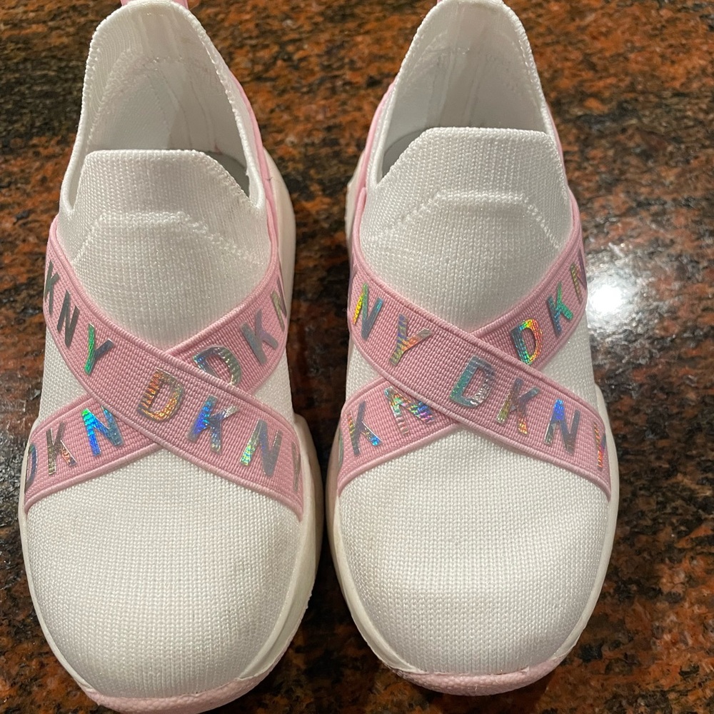 White and pink DKNY toddler girls slip on sneakers.